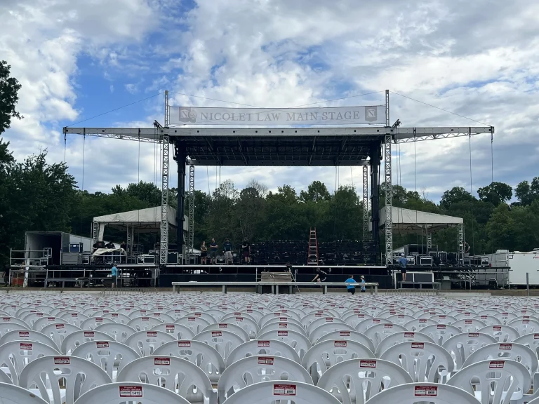 Mobile stage with roof and truss set up outdoors for a concert
